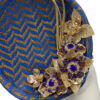 Blue and gold chevron detail percher with gold flower and quill detail.